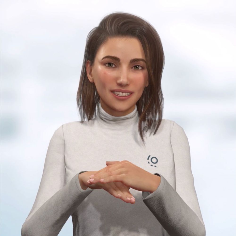 A woman wearing a white turtleneck is signing with her hands