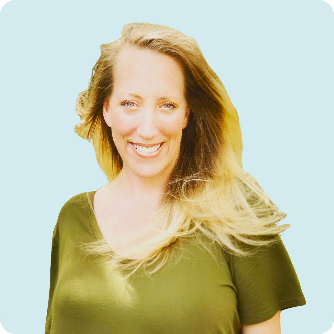 Light blue background. Cynthia is wearing a green shirt and smiling.