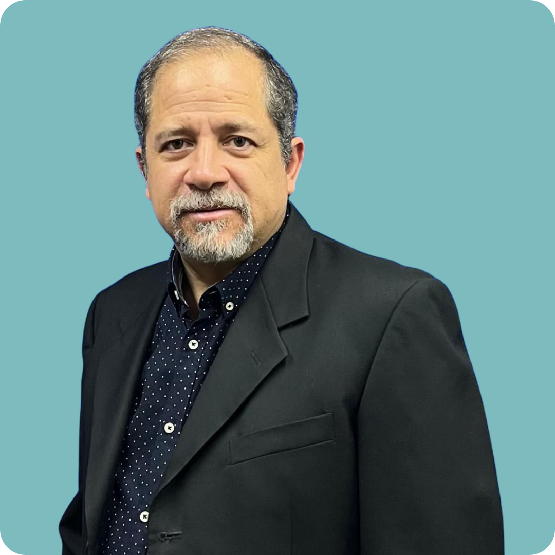 A woman wearing glasses and a red shirt is smiling for the camera.