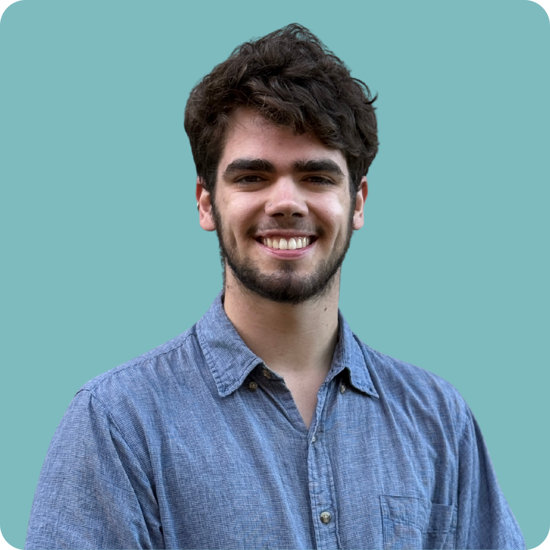 A man with a beard wearing glasses and a yellow tie