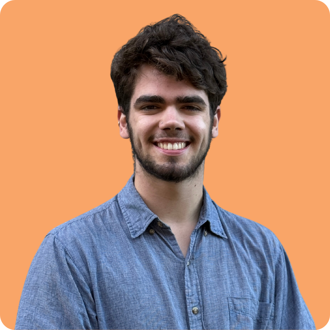 A man with a beard wearing glasses and a yellow tie