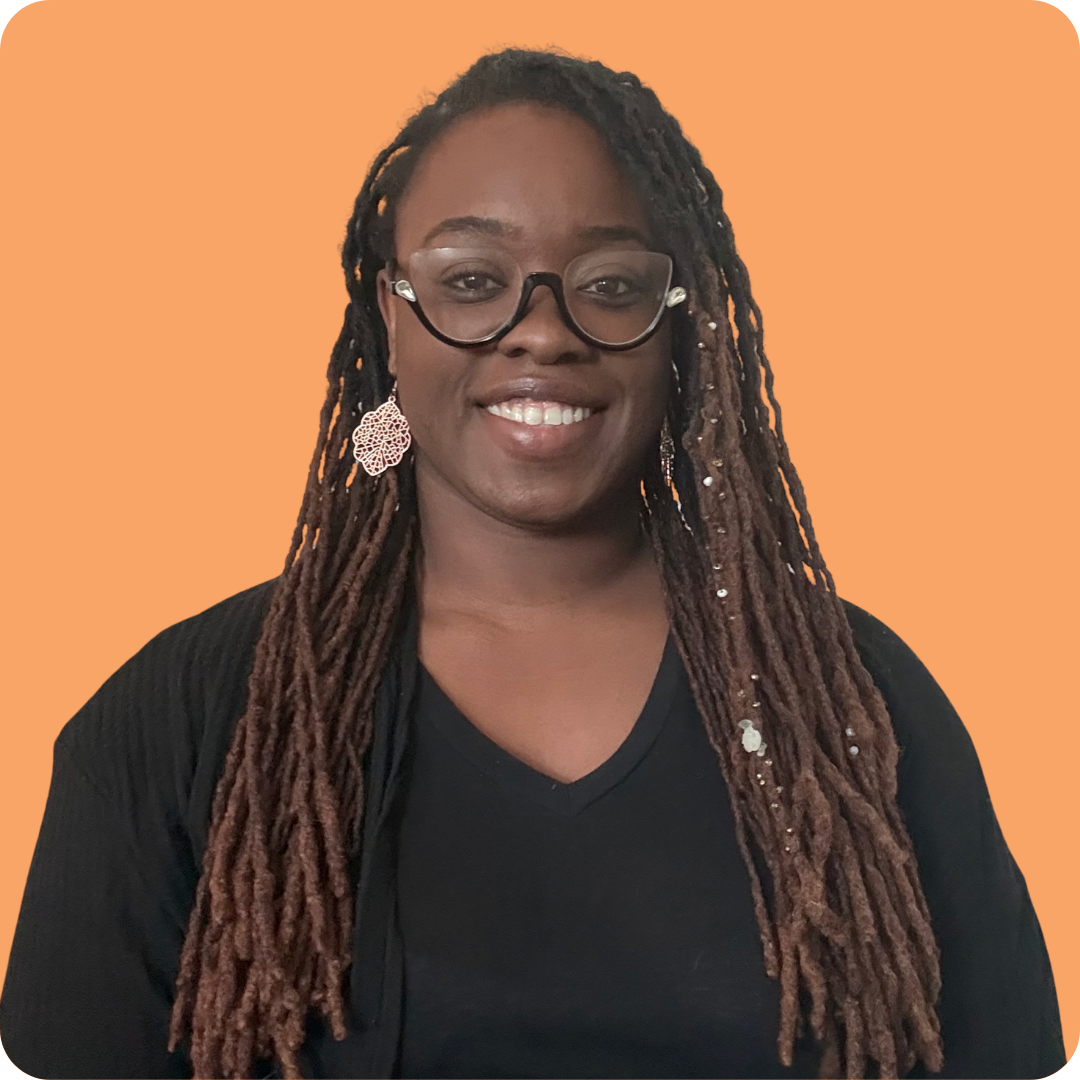A woman with long hair, black shirt, glasses, and earrings.