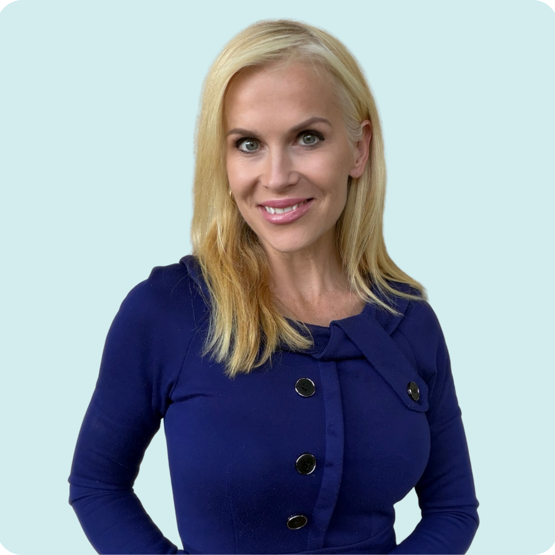 A man with a beard is wearing a black jacket and smiling.