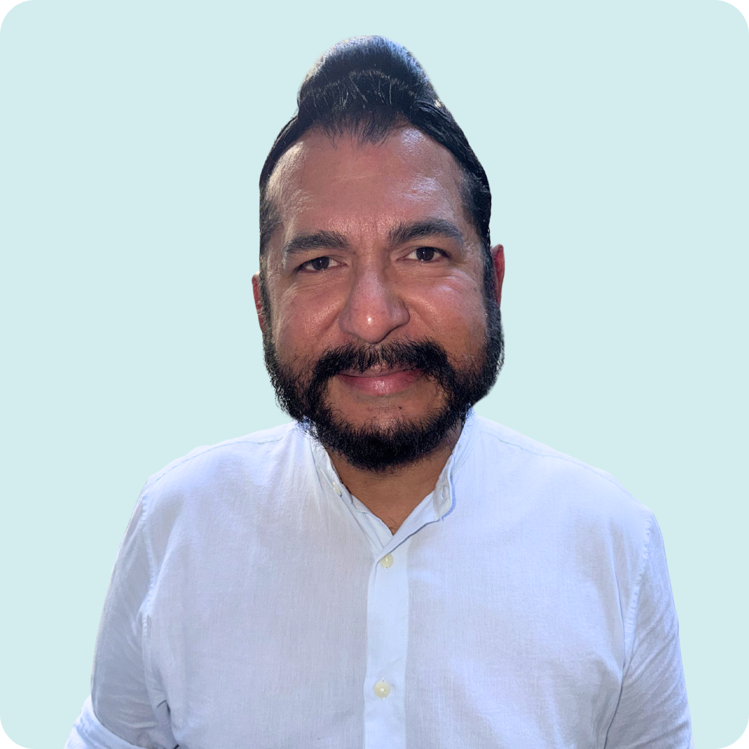 A man with a beard wearing a white shirt.