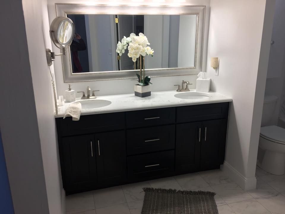A bathroom with two sinks and a large mirror