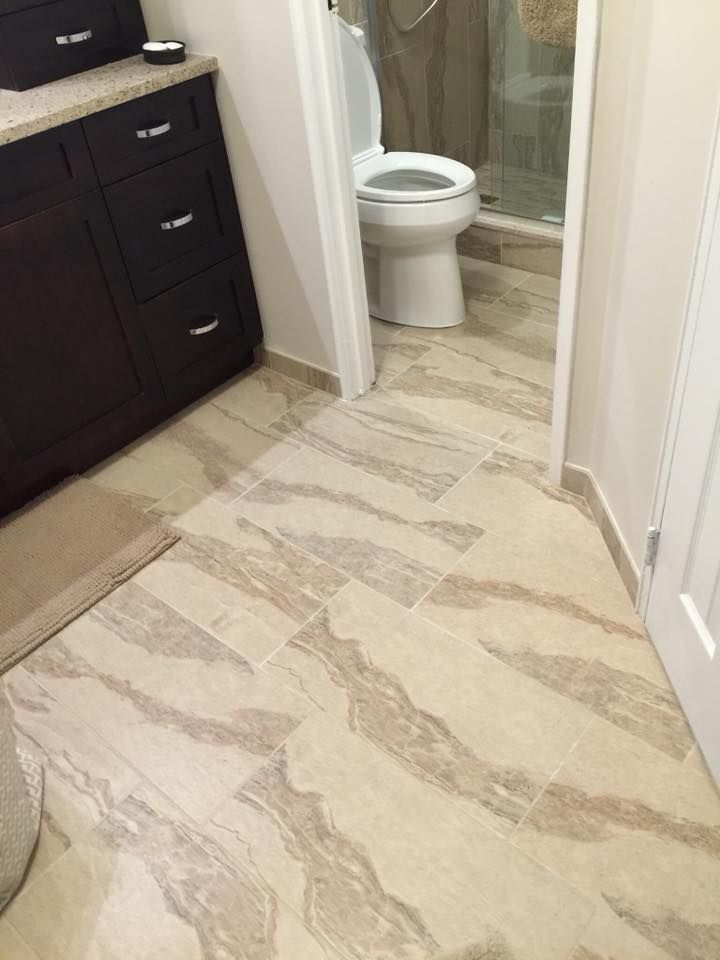 A bathroom with a toilet , sink , and shower.