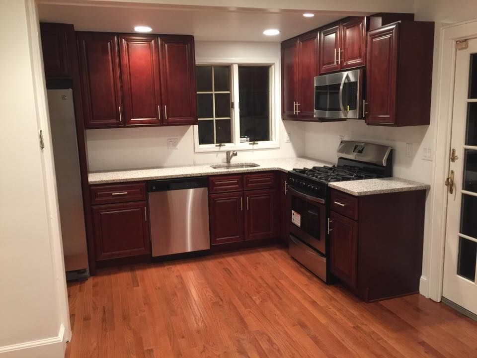 A kitchen with wooden cabinets and stainless steel appliances