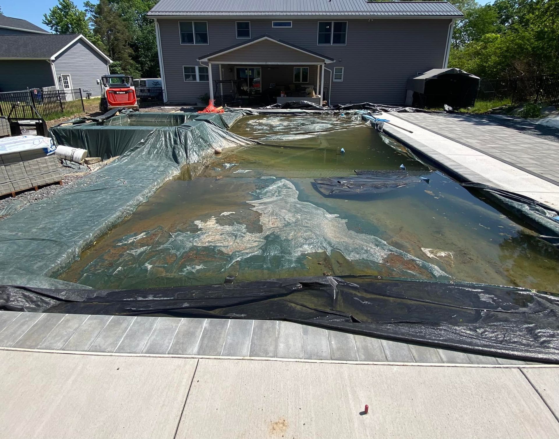 A large house with a swimming pool in front of it