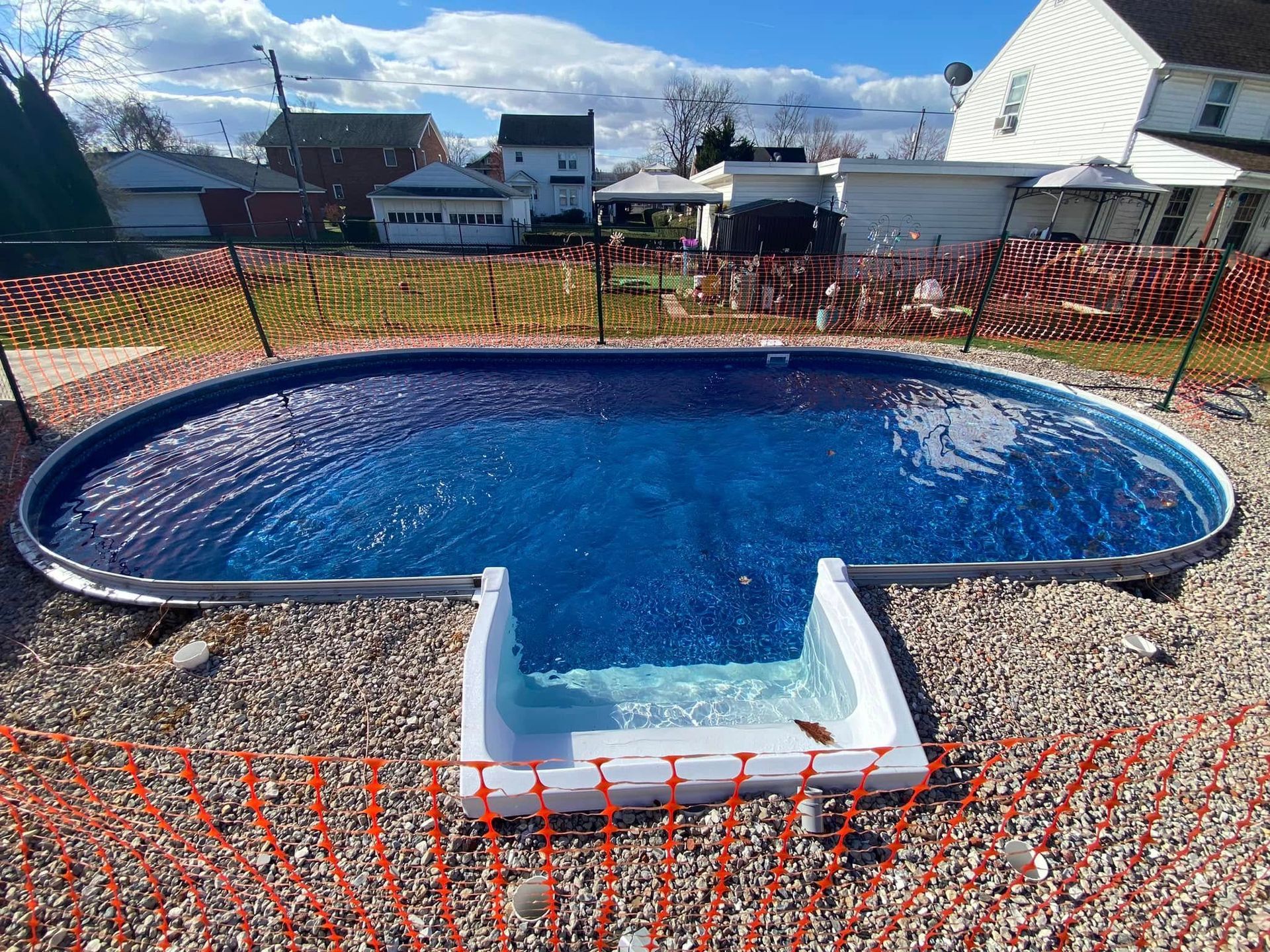 A large blue swimming pool with stairs leading to it