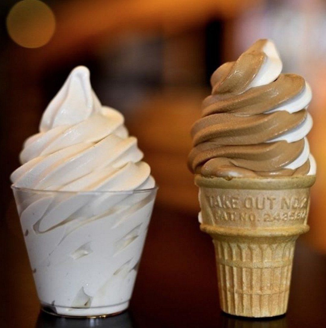 Two ice cream cones with one that says take out on it