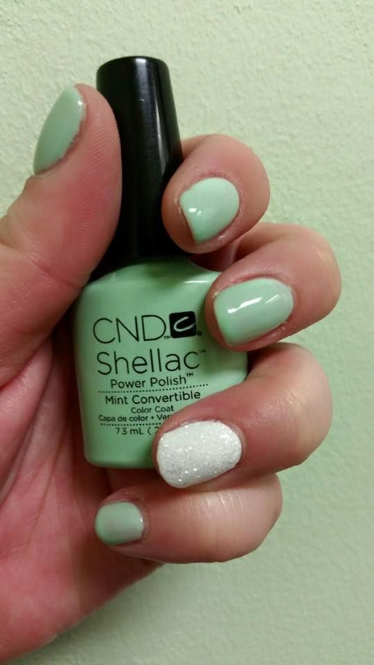 A person is holding a bottle of cnd shellac nail polish.