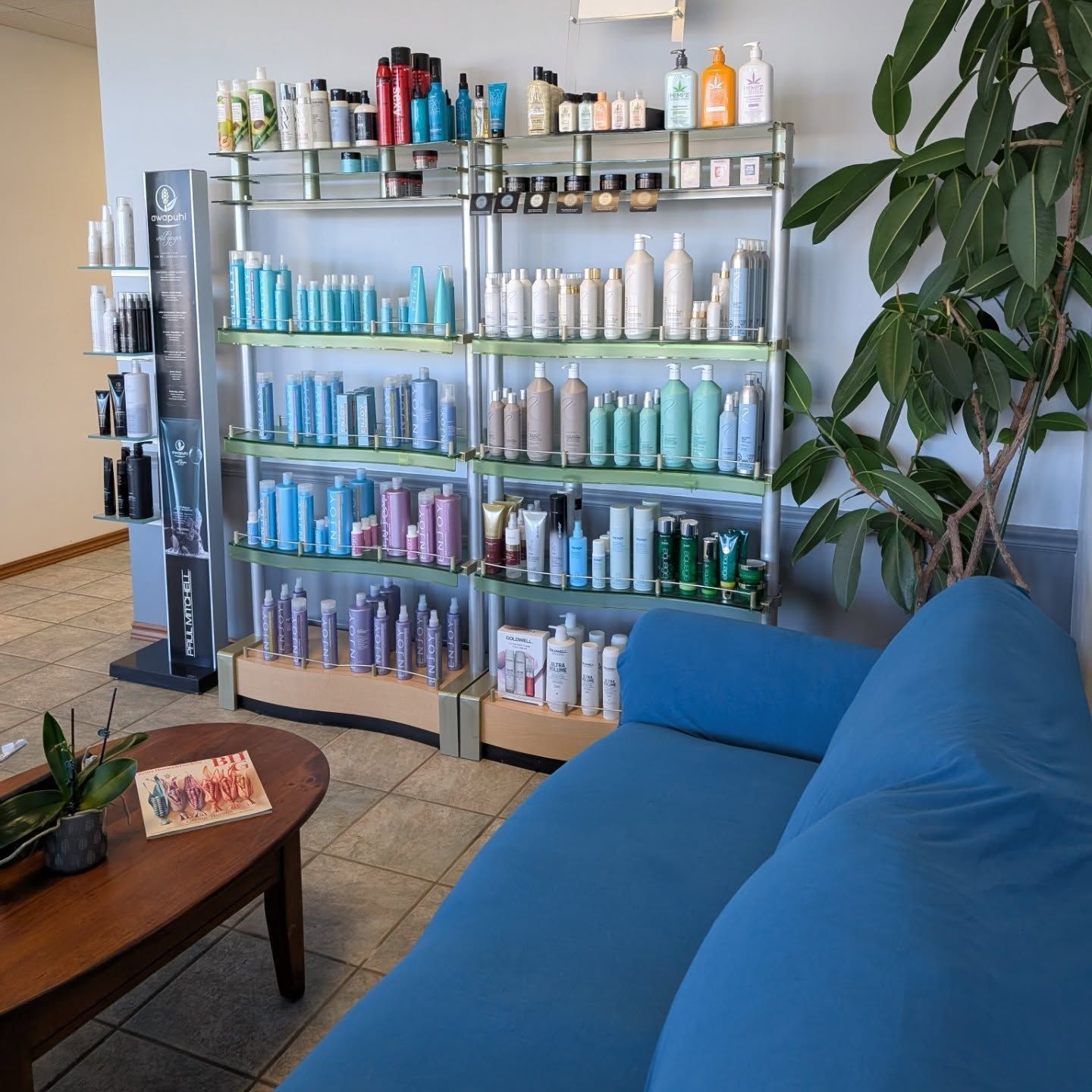 A box filled with bottles of cosmetics on a wooden table.