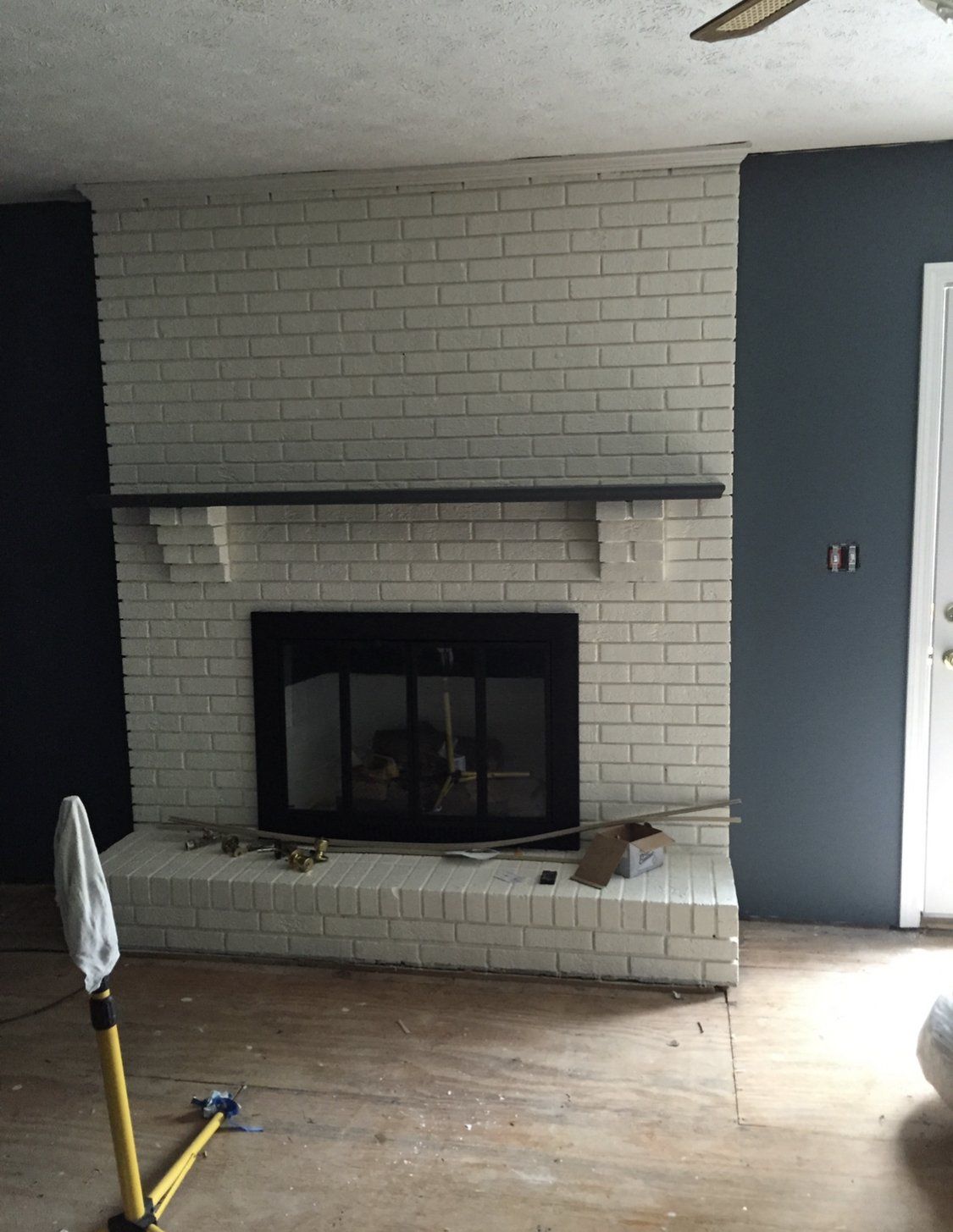 original mantle with white brick fireplace