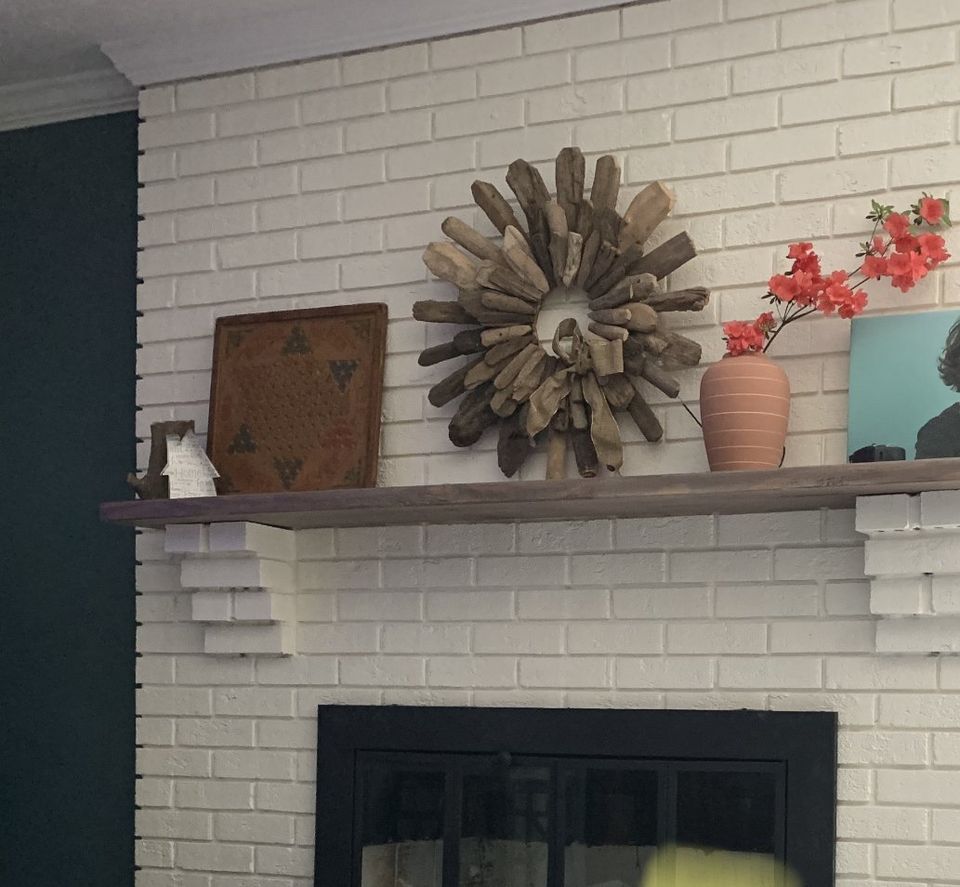white fireplace with grey stained mantle