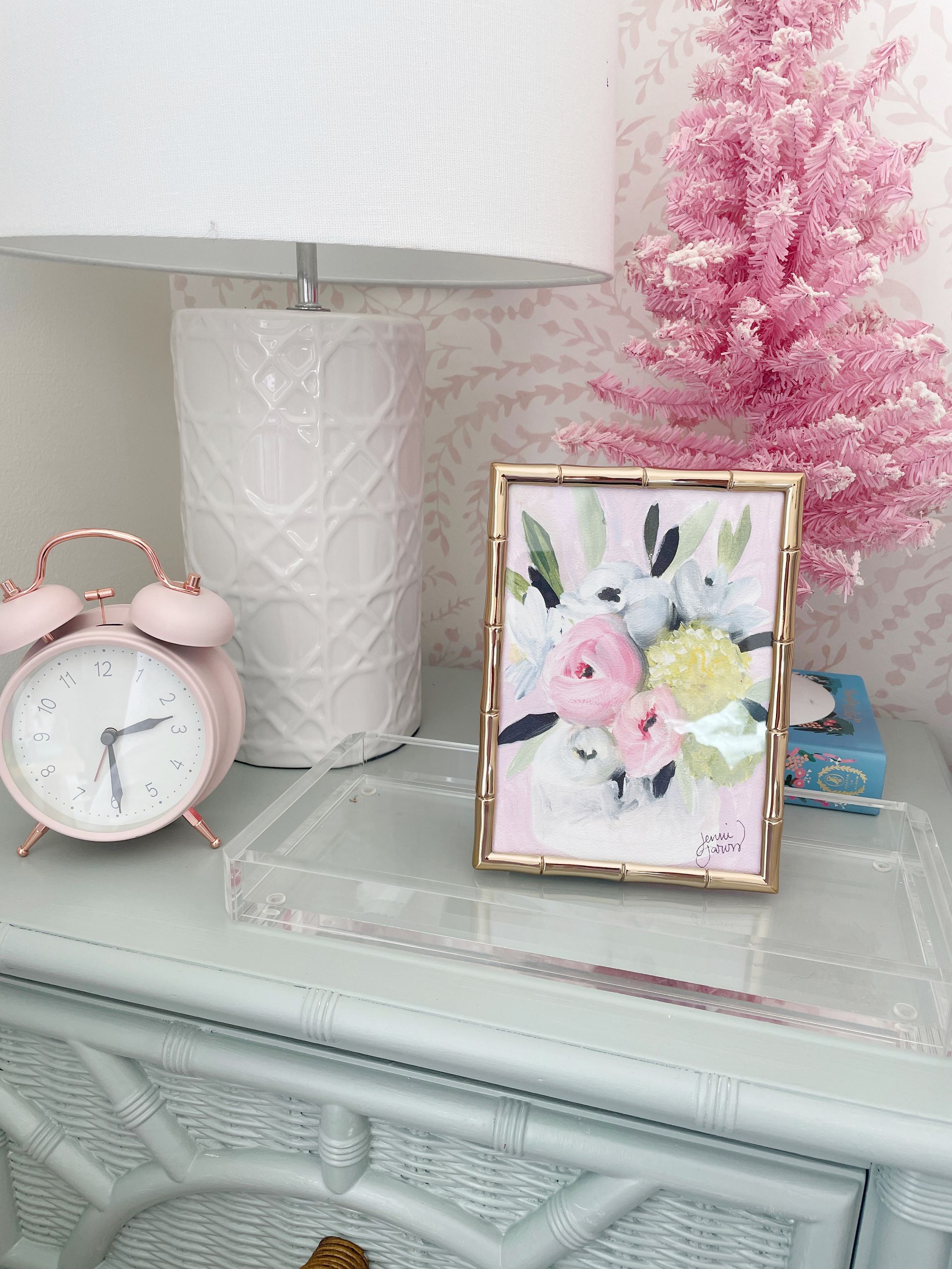 pink floral art print in gold bamboo frame on little girls nightstand