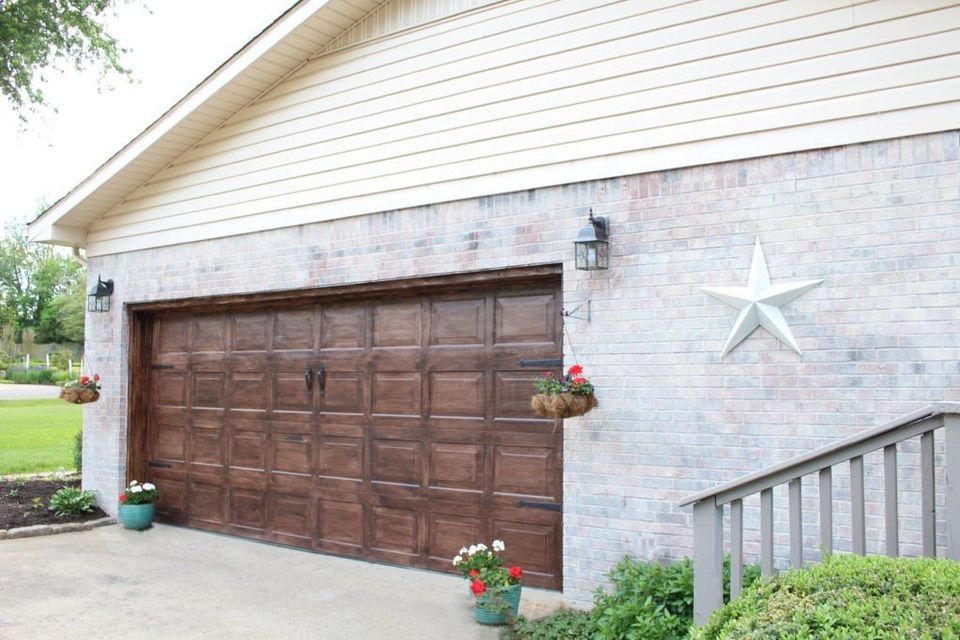 wood stained garage doow with limewashed brick