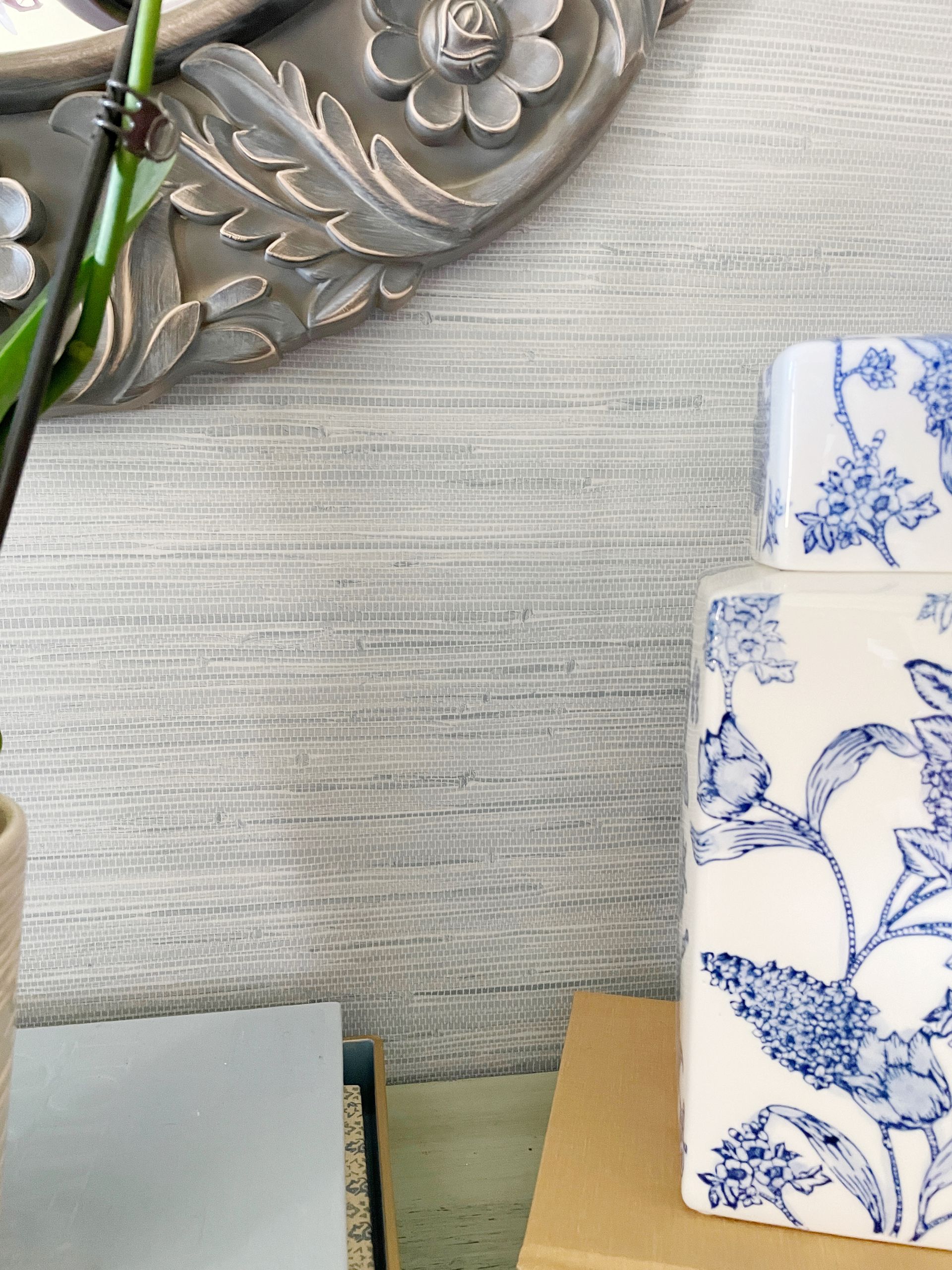 close up of blue grasscloth peel and stick wallpaper