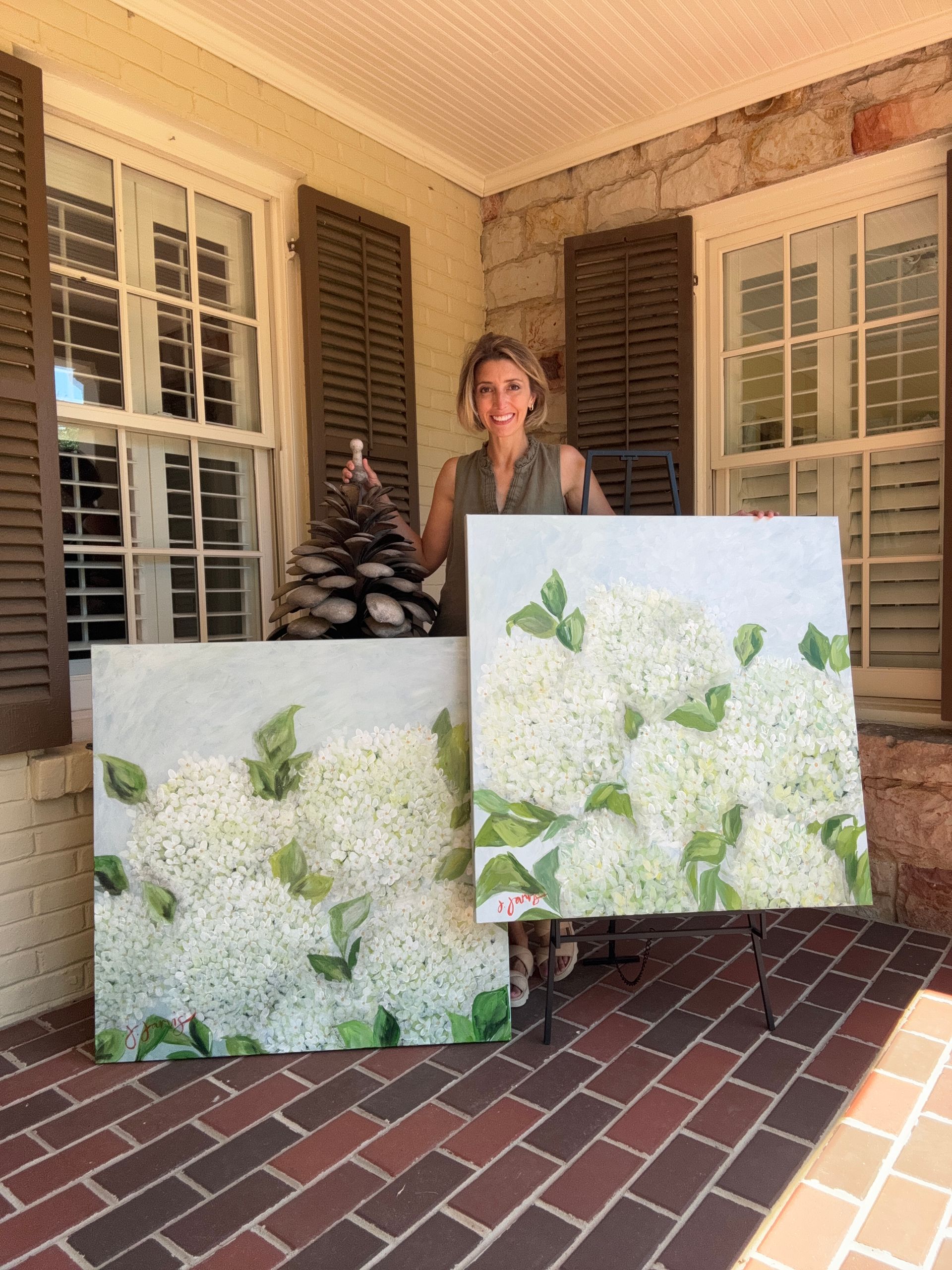 Artist with two large paintings of hydrangeas