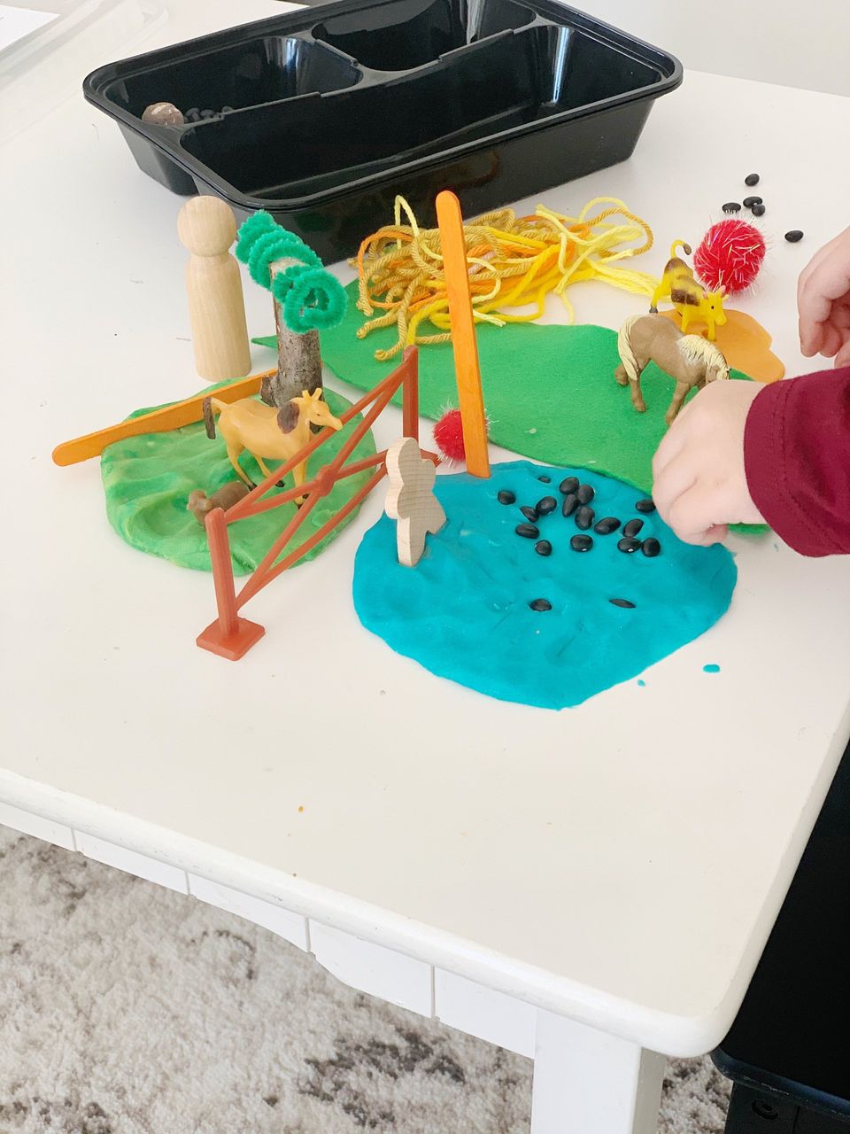 farm sensory kit with toddler playing