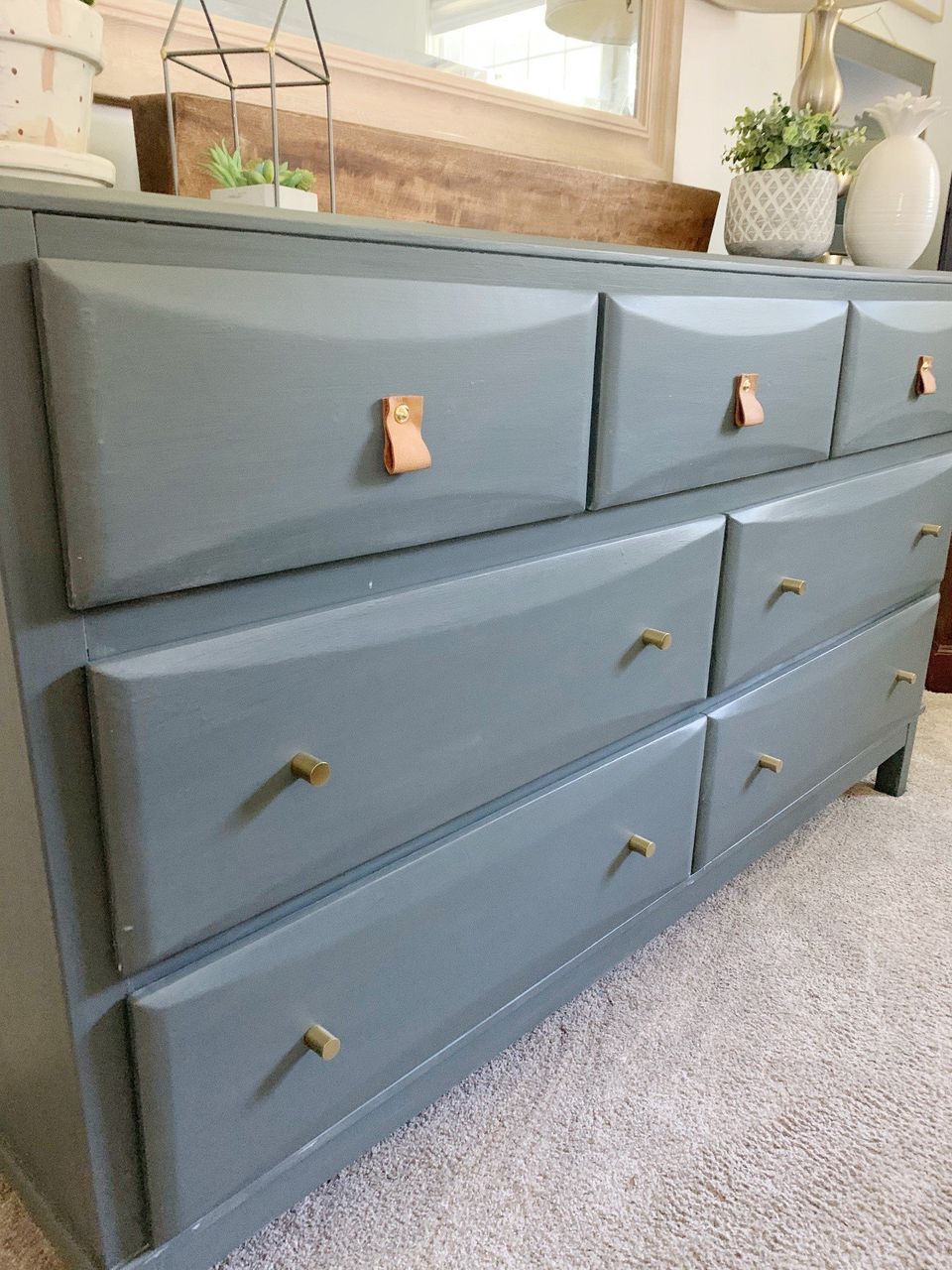 leather drawer pulls on gray dresser with gold knobs