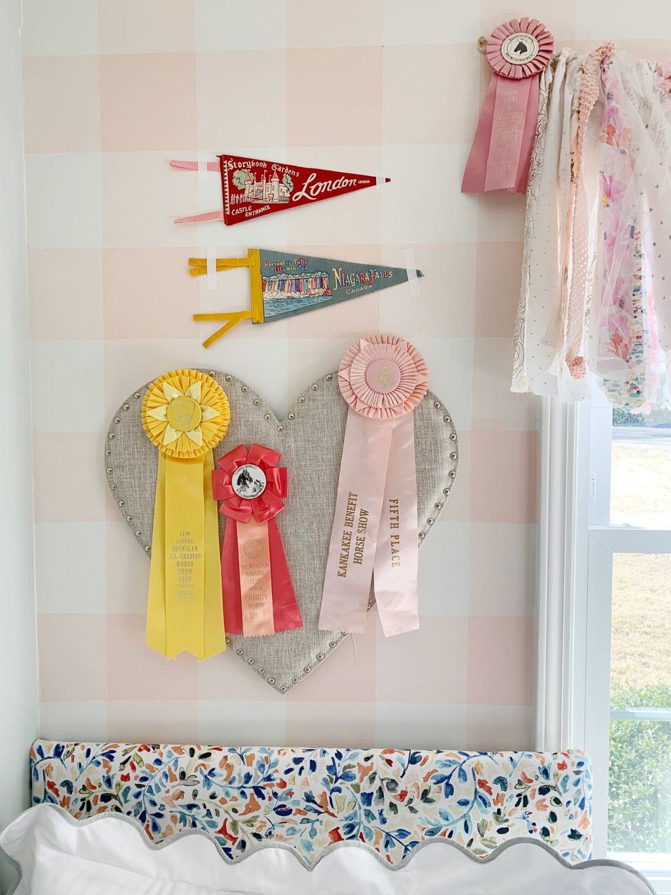 vintage pennants and horse show ribbons above little girls bed
