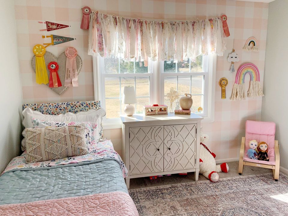little girls pink bedroom with vintage horse show ribbons and pennants