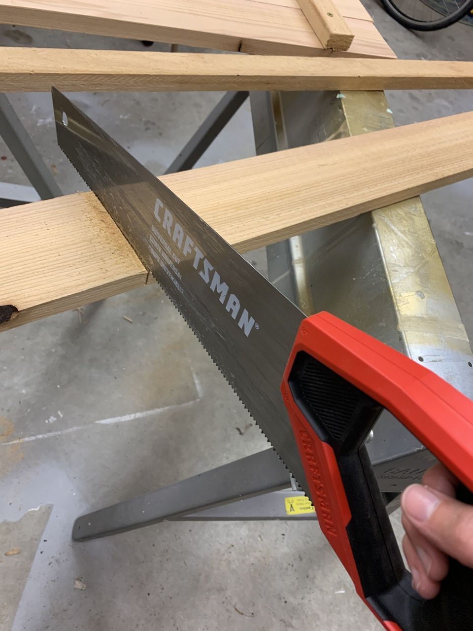 cutting cedar boards with craftsman hand saw
