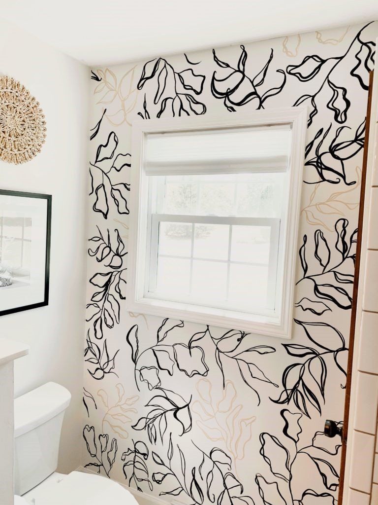 white bathroom with faux black and tan wallpaper