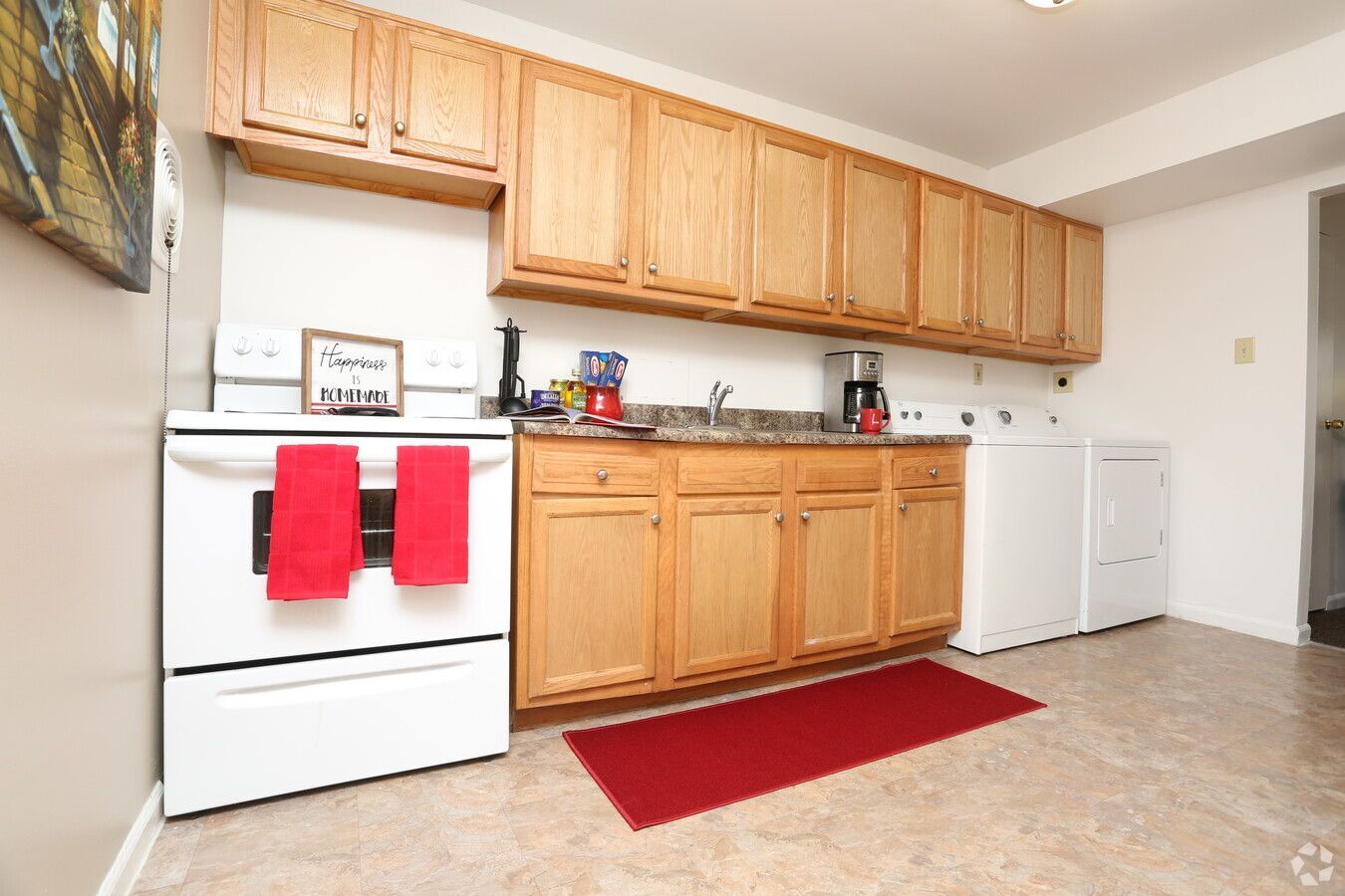 A kitchen with wooden cabinets and white appliances