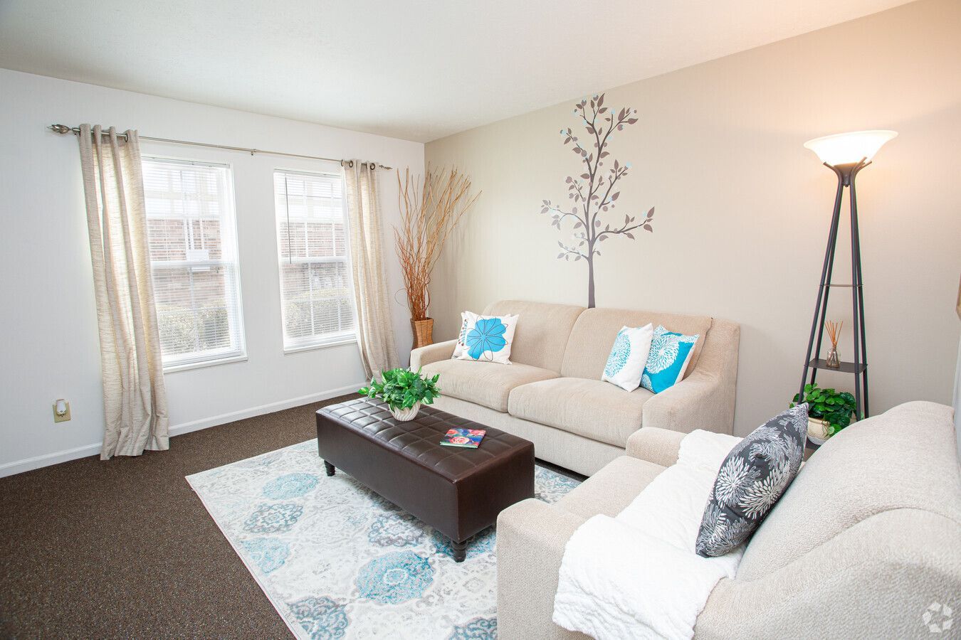 A living room with two couches , a coffee table , and a lamp.