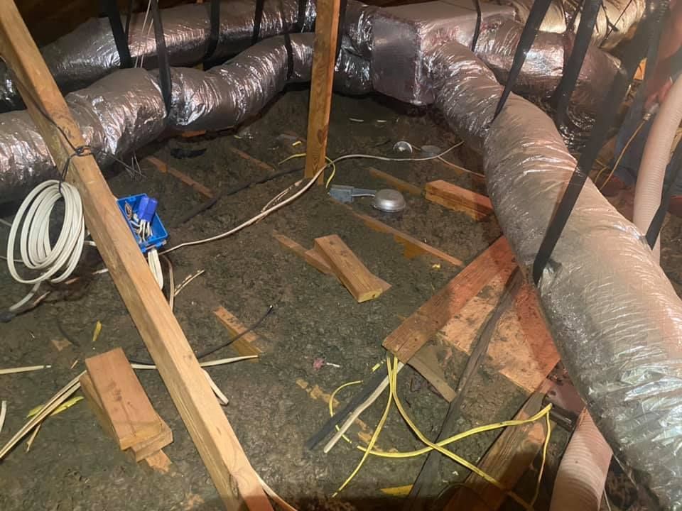 Attic with HVAC ductwork, electrical wiring, and wooden structural beams.
