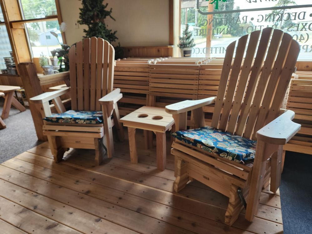 Two wooden chairs are sitting on a wooden floor.