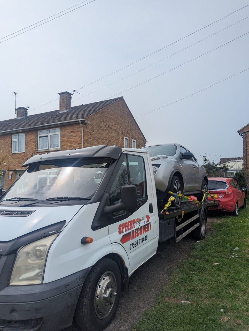 A recovery truck is carrying a car on the back of it in leicester city UK