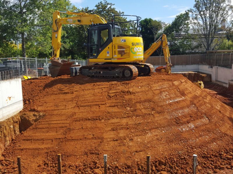 A man is using a drill in a bathroom.