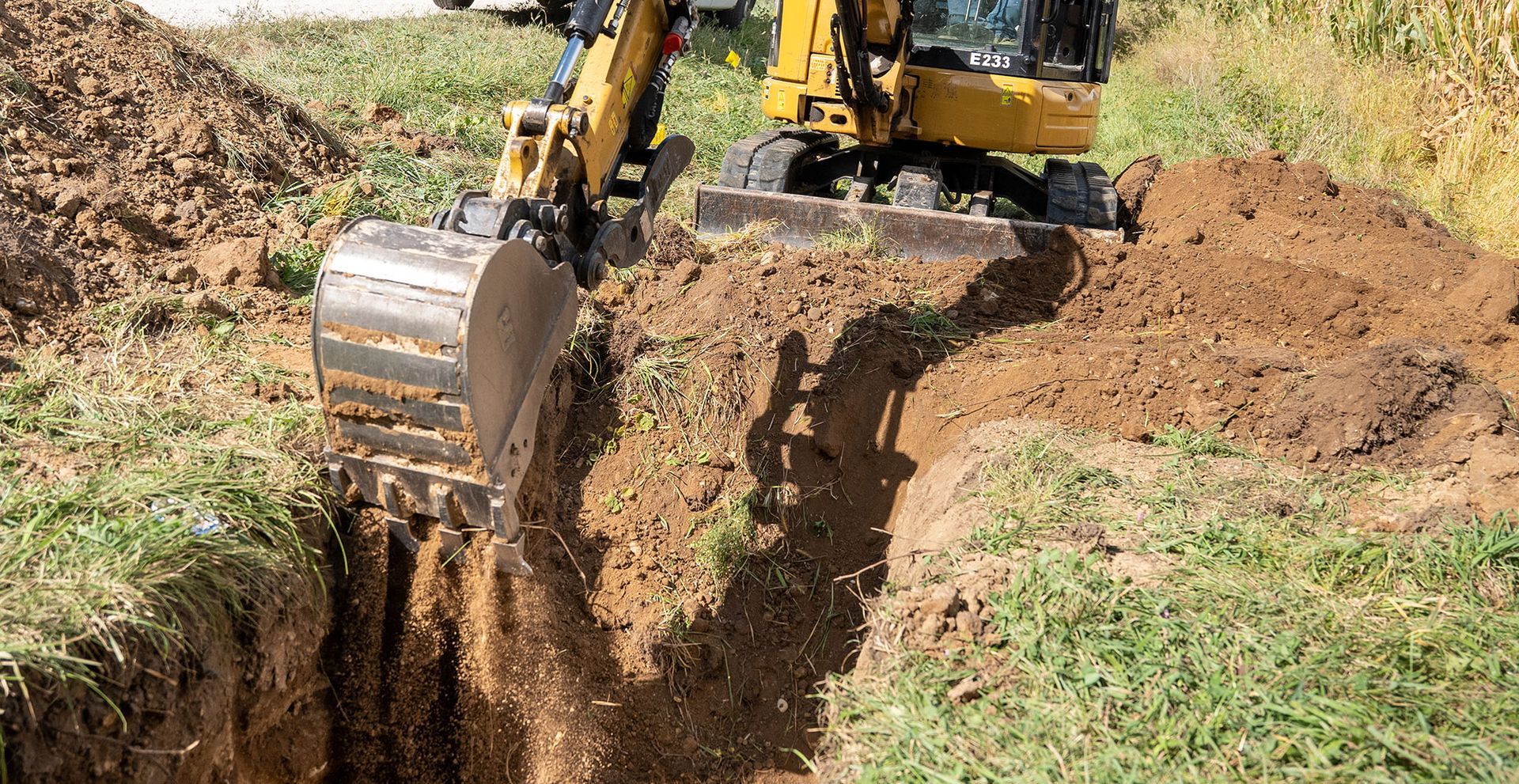 A man is using a drill to drill a hole in a kitchen cabinet.