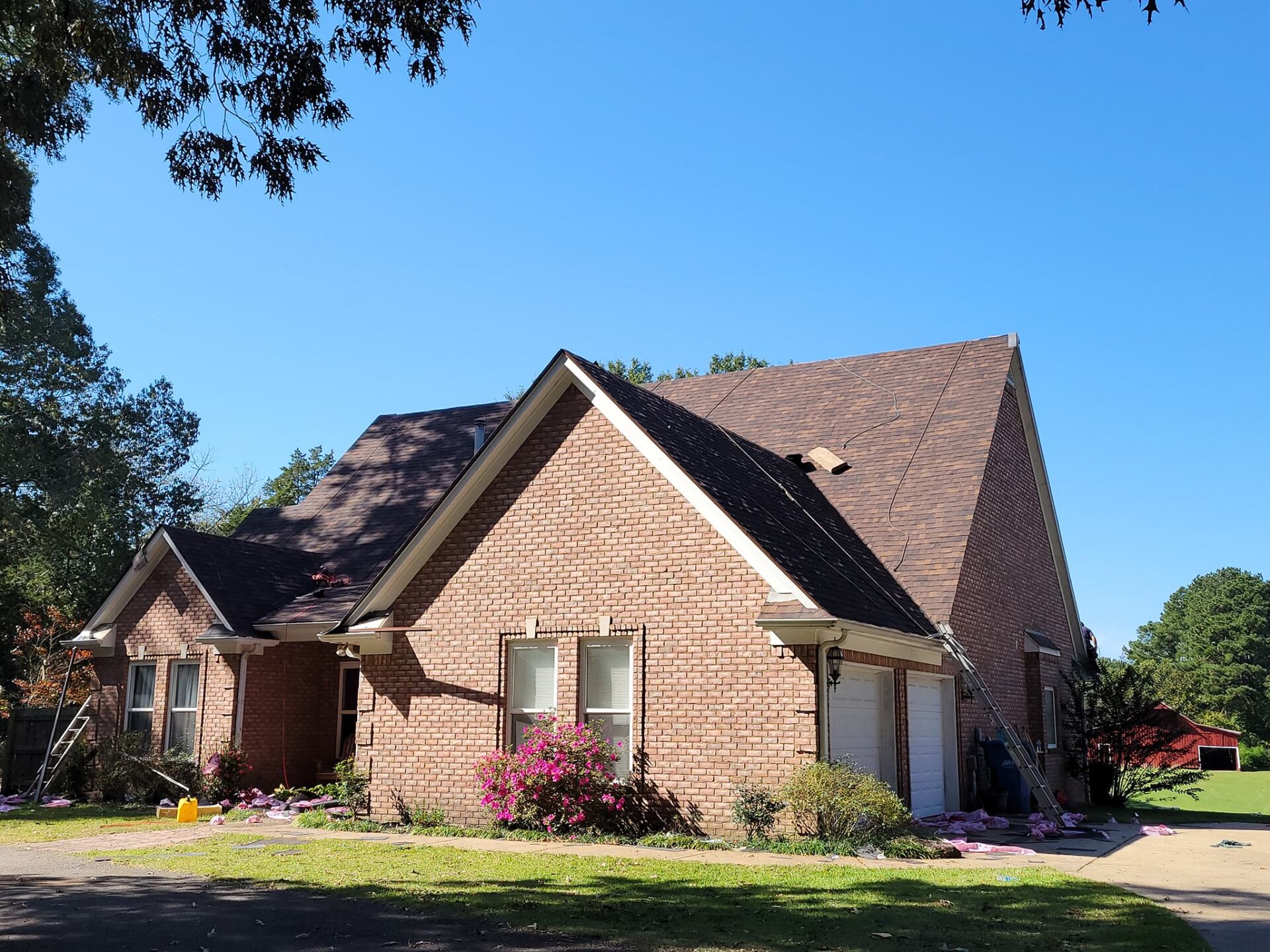 A large brick house with a brown roof