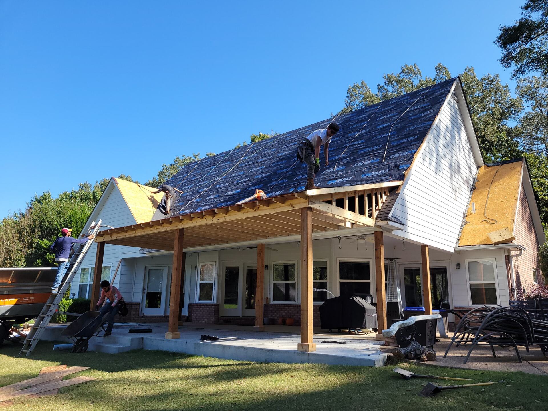 A man is working on the roof of a house
