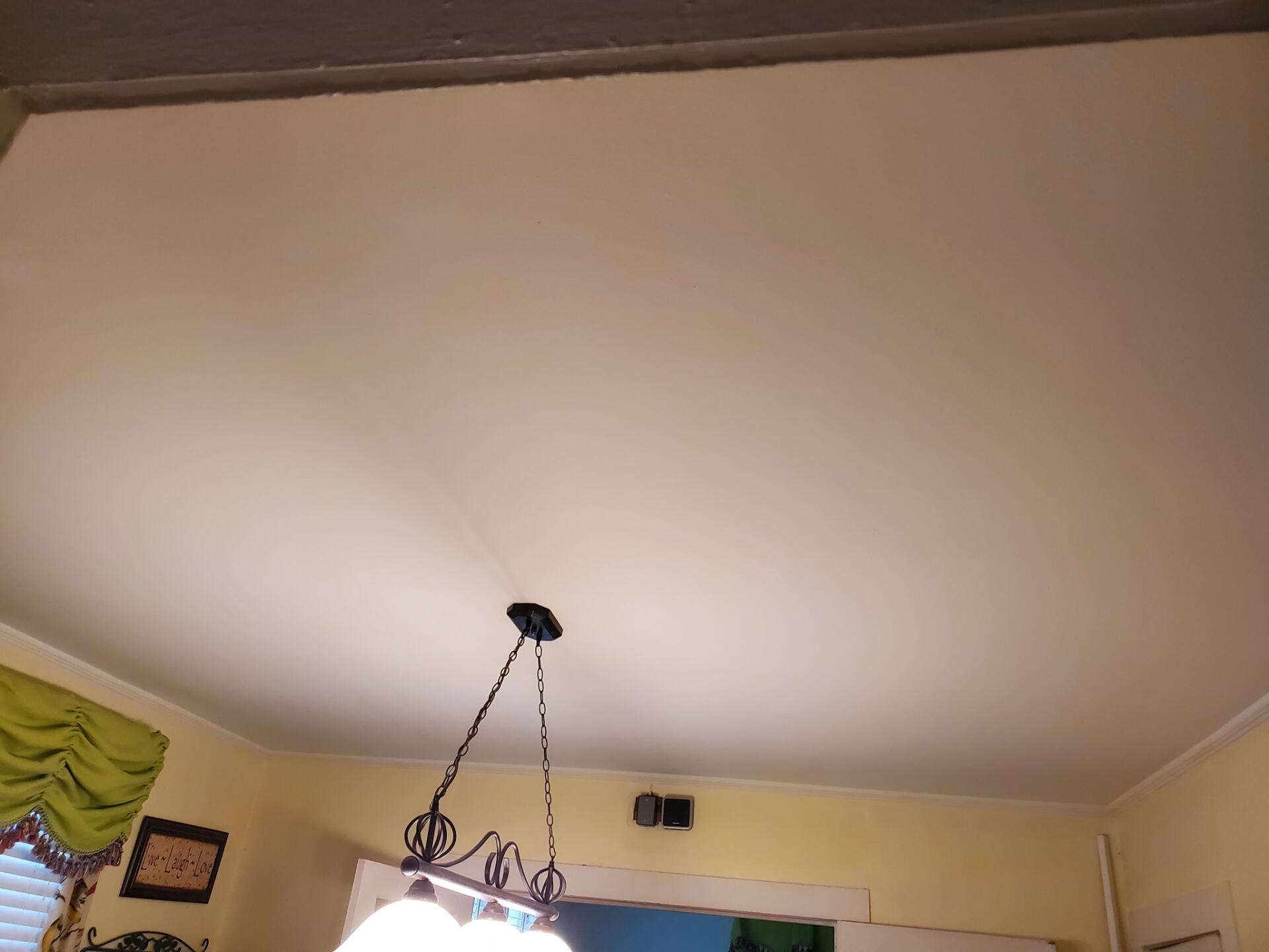 A chandelier is hanging from the ceiling of a room.