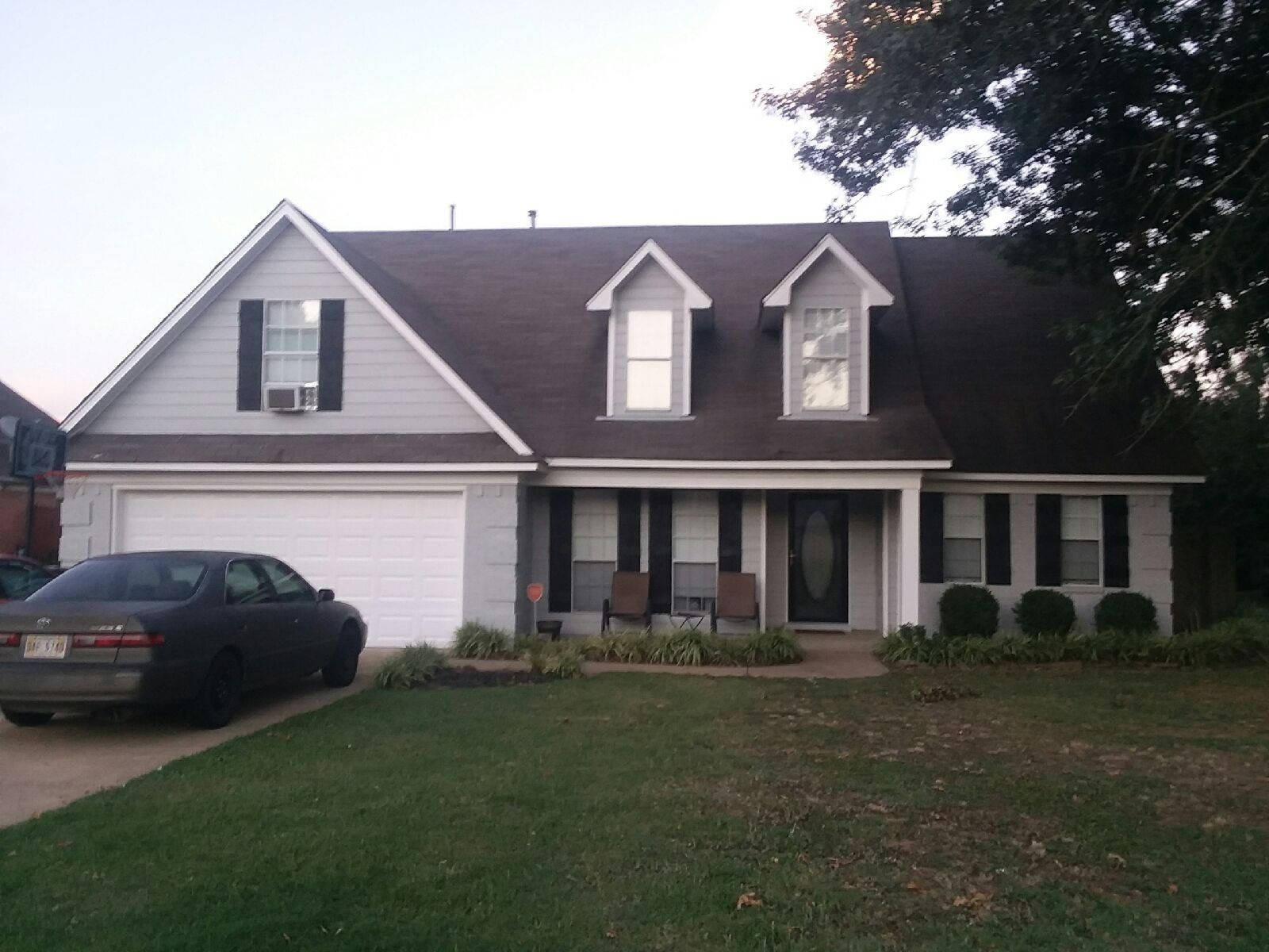 A house with a car parked in front of it