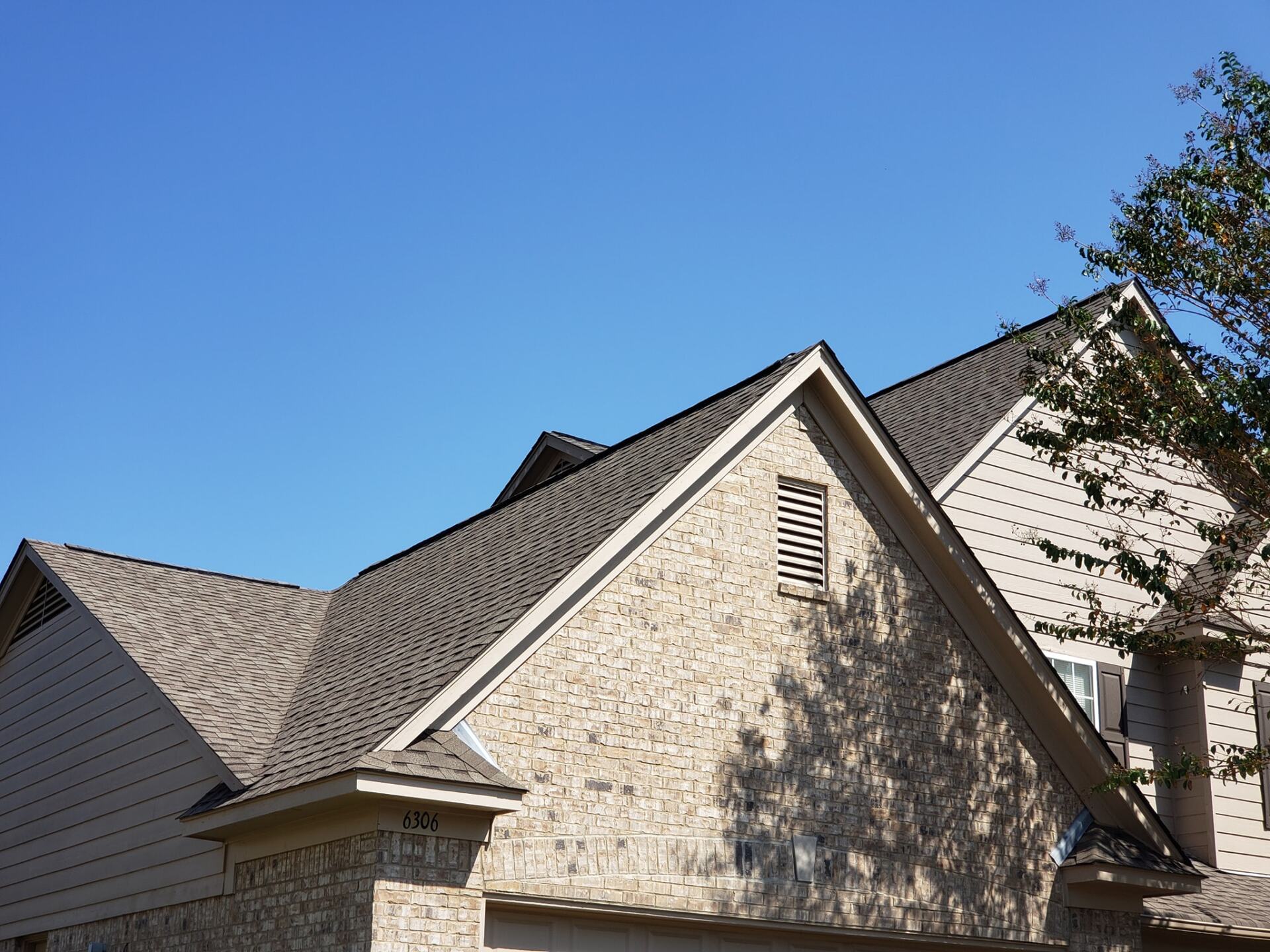 The roof of a house with a blue sky in the background