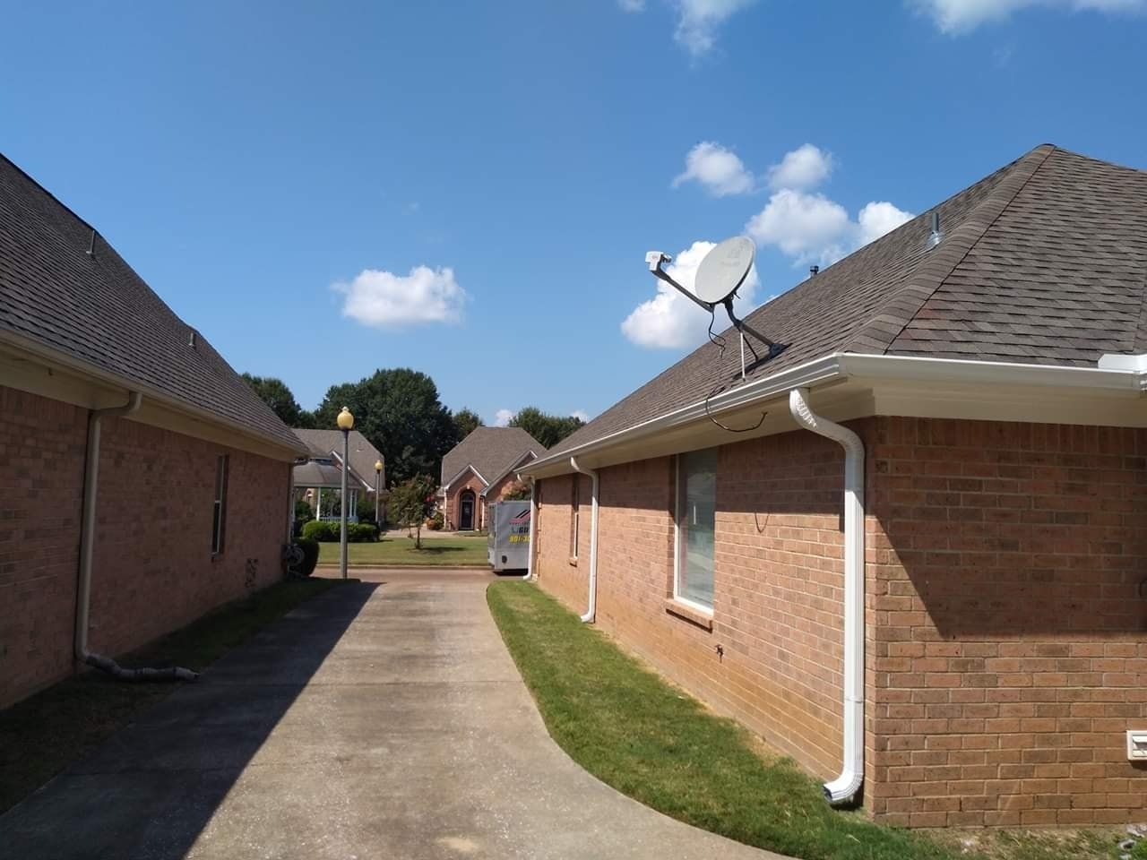 A brick house with a satellite dish on the roof