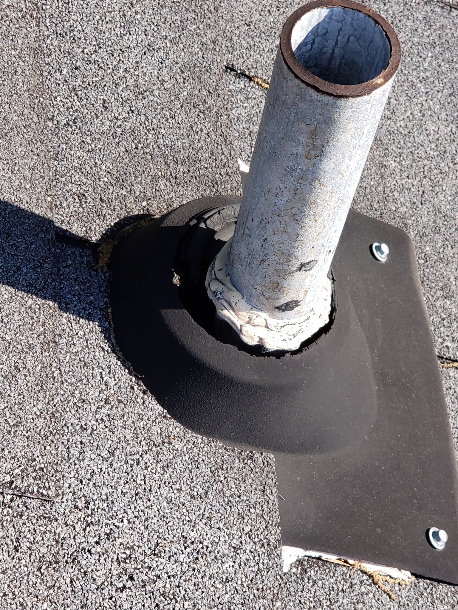 A pipe is sitting on top of a concrete surface.
