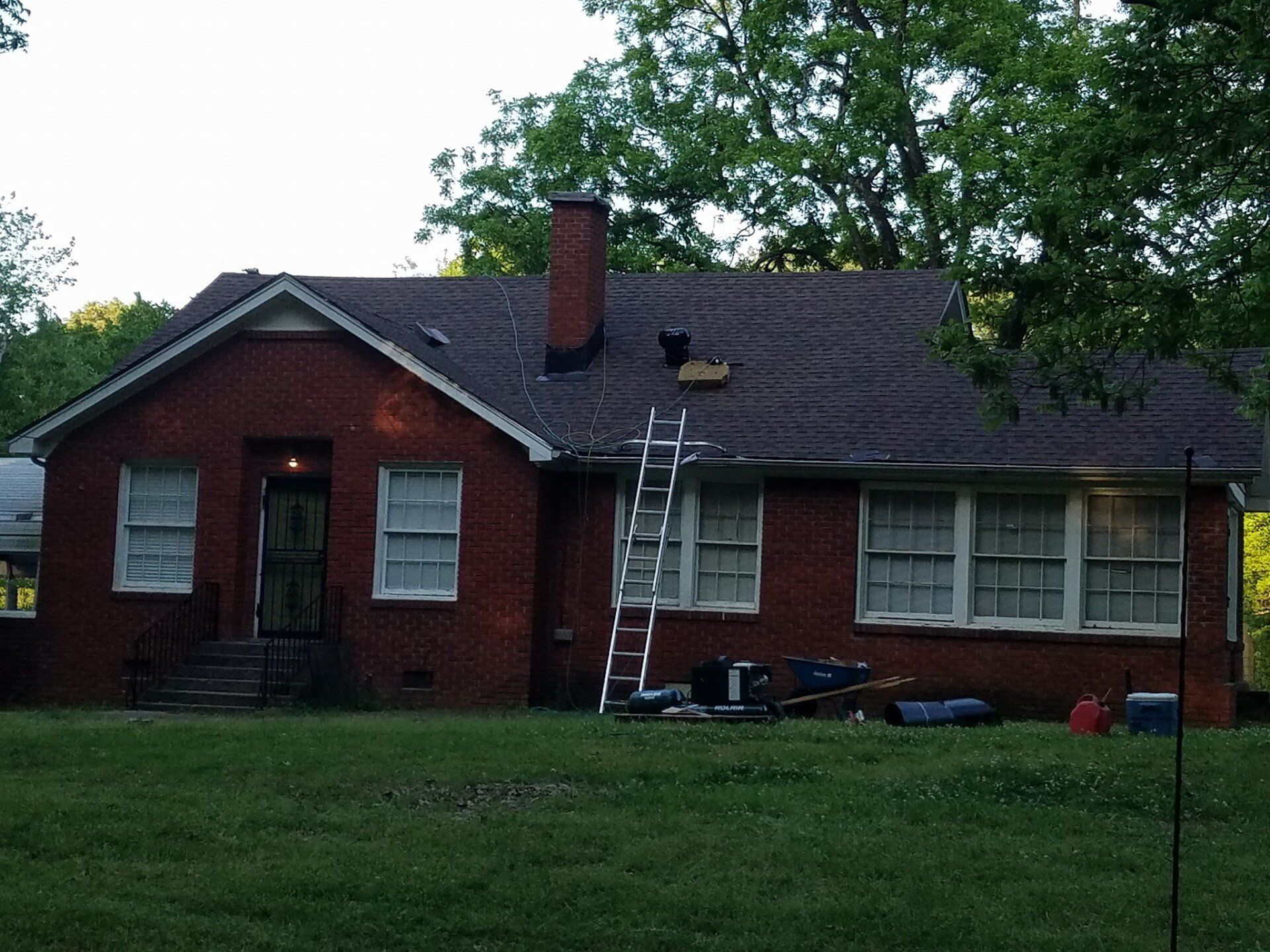 A brick house with a ladder in front of it