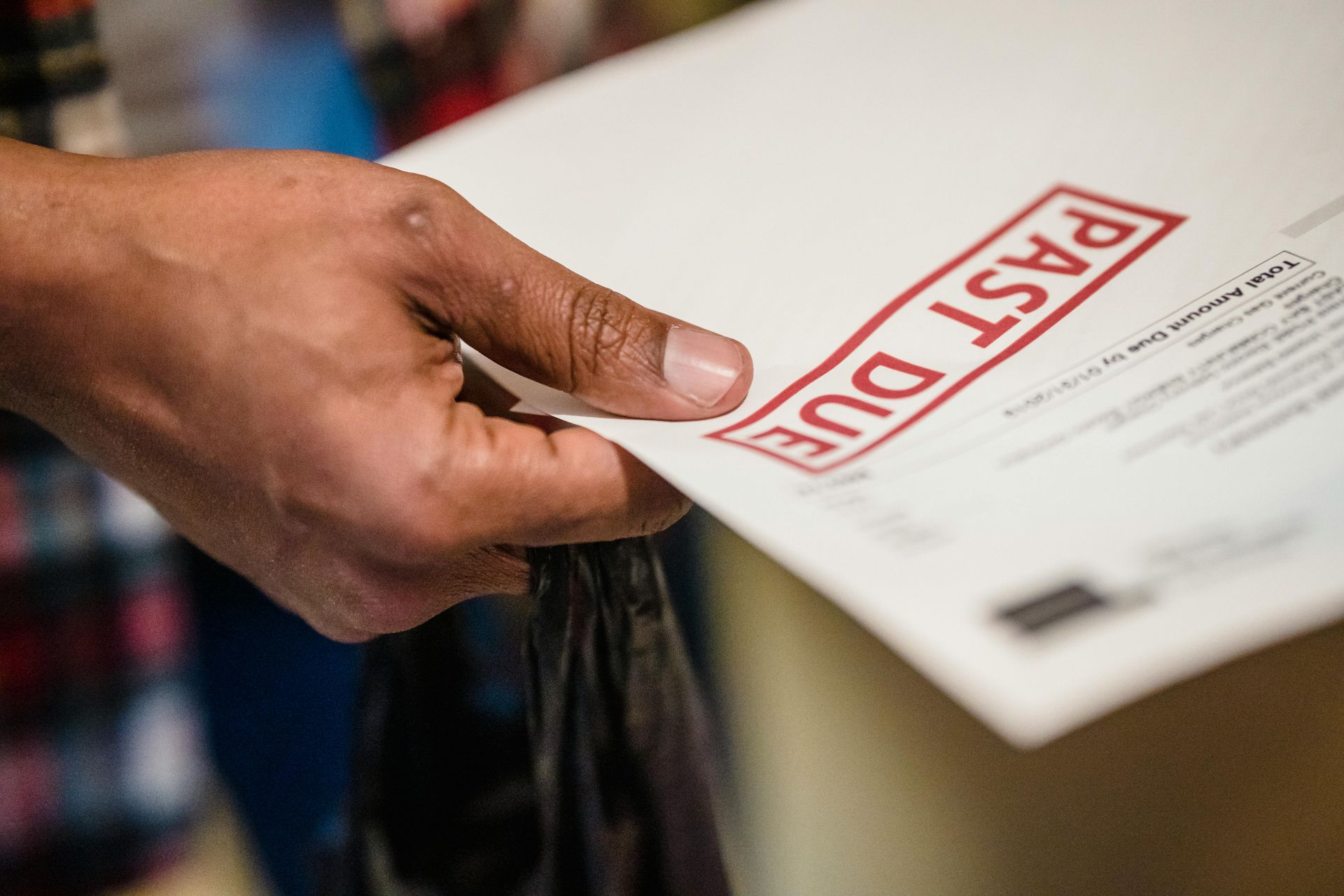 Person holding a bill labeled