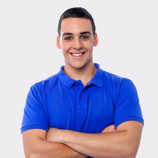 Young man with crossed arms wearing a blue polo shirt, smiling.