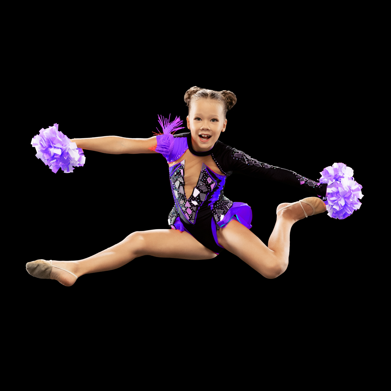 Young girl in dance costume doing a split leap in mid-air, holding purple pom-poms. She smiles with eyes open against a black background.
