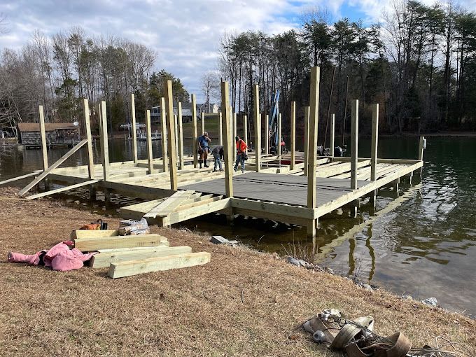 A wooden dock is being built on the shore of a lake.