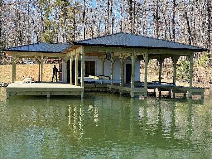 A large house is sitting on top of a body of water.