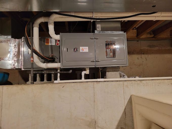 A ceiling with a box and pipes hanging from it.