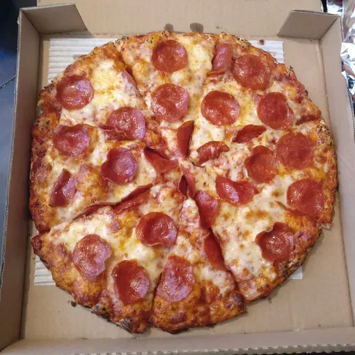 Pepperoni pizza cut into slices, in a cardboard box.